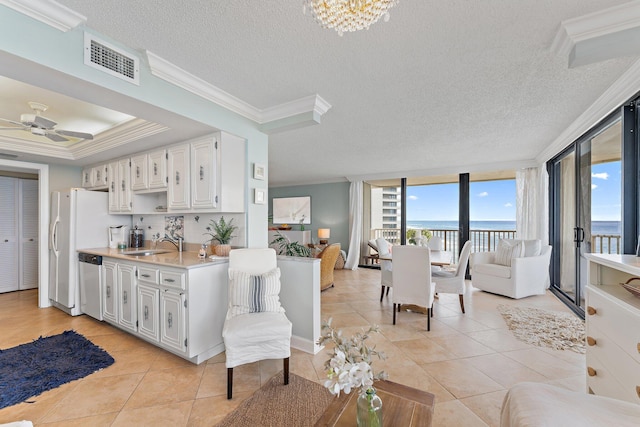 kitchen with white cabinetry, stainless steel dishwasher, and ornamental molding