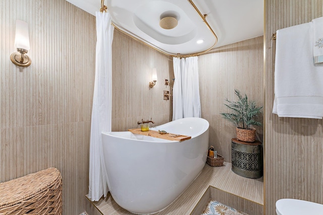 bathroom featuring a washtub and tile patterned flooring