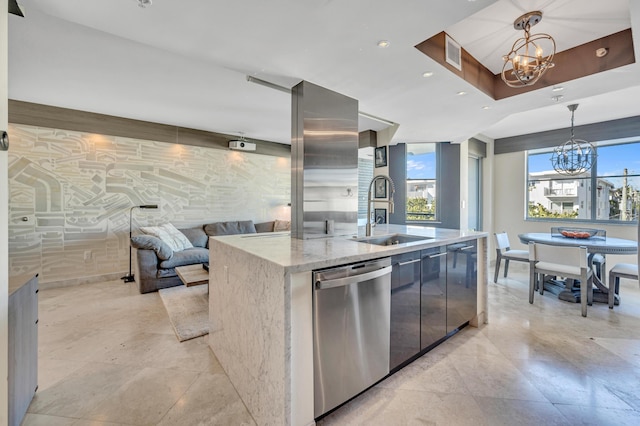 kitchen with sink, an inviting chandelier, dishwasher, hanging light fixtures, and an island with sink