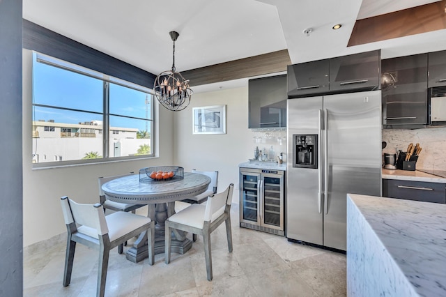 dining area with a notable chandelier and wine cooler