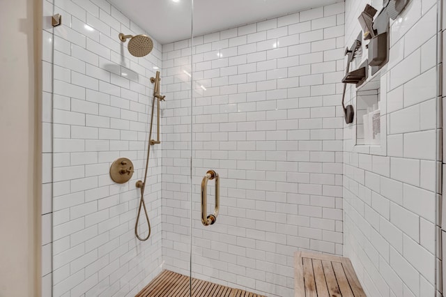 bathroom with a shower with door