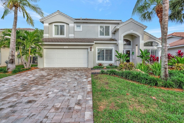 view of front of house with a garage and a front lawn