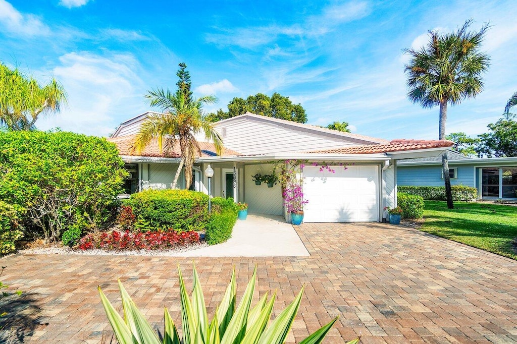 ranch-style house with a front lawn and a garage