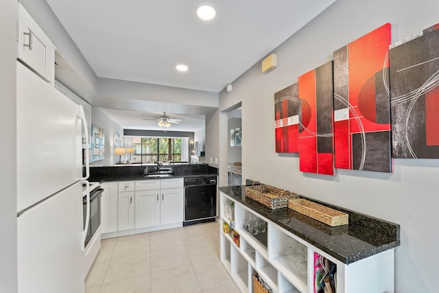 kitchen featuring dishwasher, sink, ceiling fan, white fridge, and white cabinetry