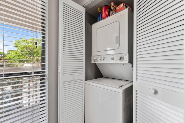 washroom with stacked washer / drying machine