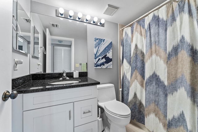 bathroom with vanity, toilet, and walk in shower