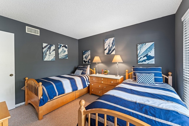 bedroom featuring a textured ceiling and carpet floors