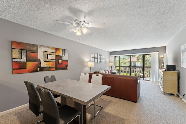 carpeted dining area featuring a textured ceiling and ceiling fan