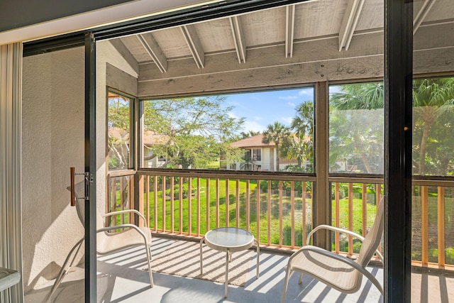 sunroom featuring vaulted ceiling