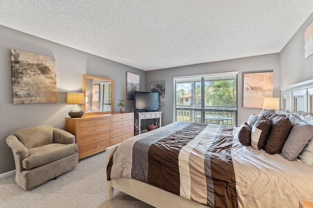 bedroom featuring carpet floors and a textured ceiling