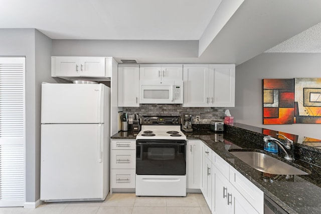 kitchen with dark stone countertops, sink, white cabinets, and white appliances