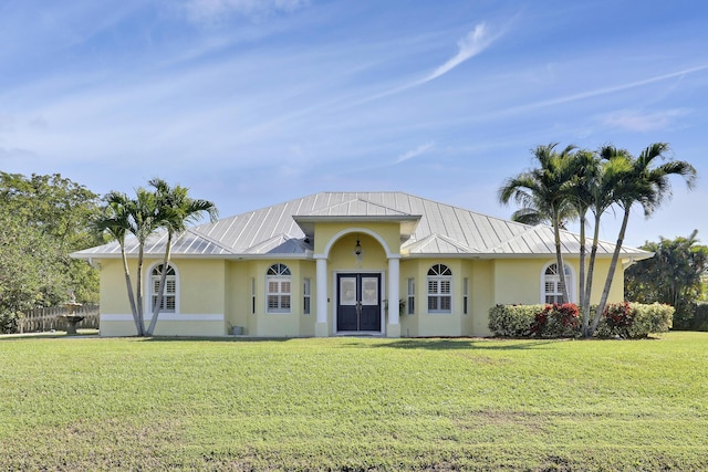 view of front facade with french doors and a front lawn