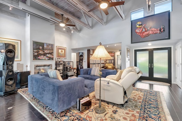 living room featuring hardwood / wood-style floors, beam ceiling, wood ceiling, high vaulted ceiling, and french doors