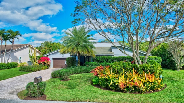 view of front of house with a front yard and a garage