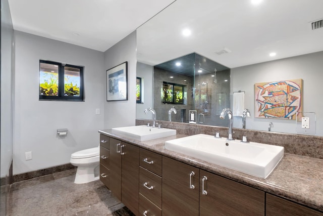 bathroom with toilet, a shower with door, and vanity