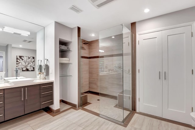 bathroom with walk in shower and vanity