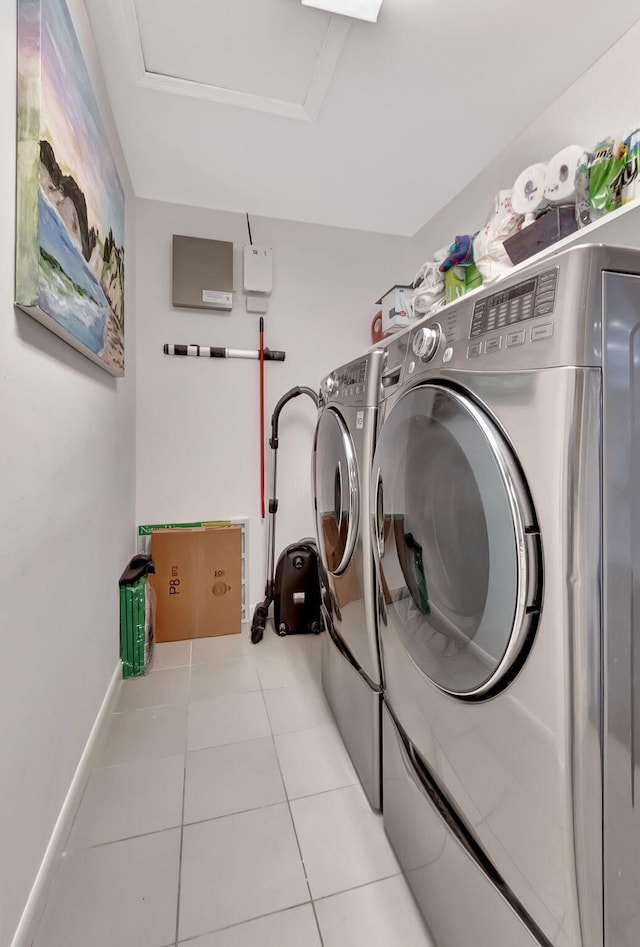 washroom with washer and dryer and light tile patterned flooring