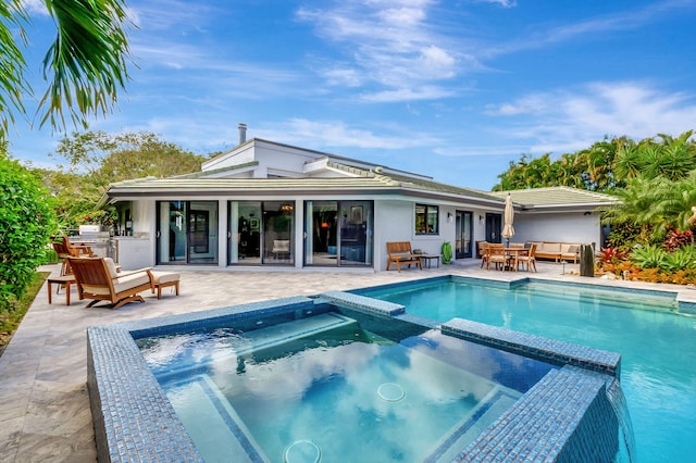 view of pool with an in ground hot tub and a patio