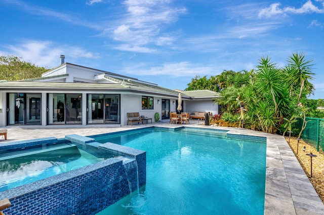 view of pool with an in ground hot tub and a patio