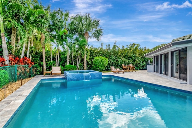 view of pool featuring a patio area and an in ground hot tub