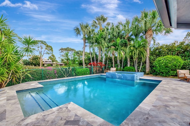 view of swimming pool featuring an in ground hot tub