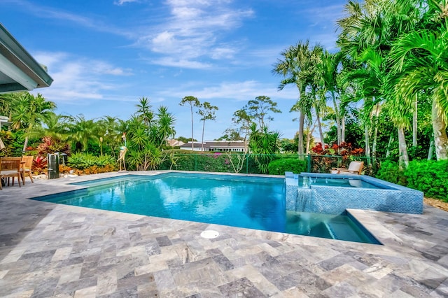 view of swimming pool featuring a patio area and an in ground hot tub