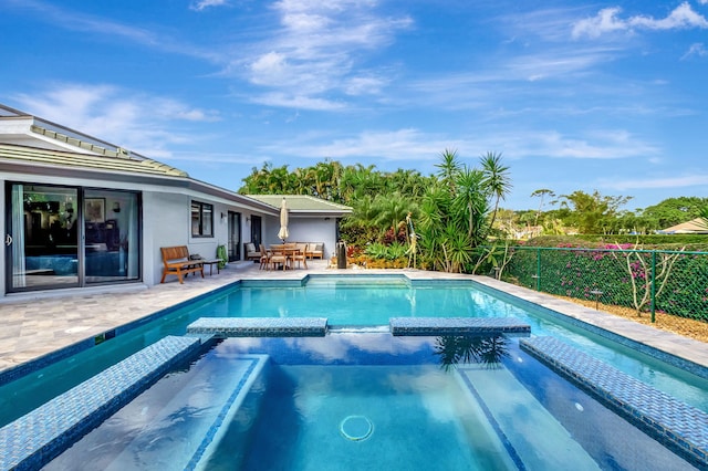 view of swimming pool with a patio area and an in ground hot tub