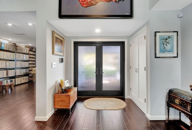 foyer featuring dark hardwood / wood-style floors and french doors