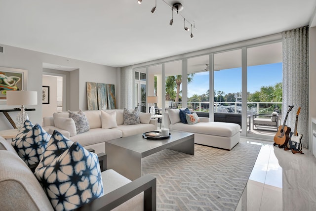 tiled living room featuring expansive windows and rail lighting