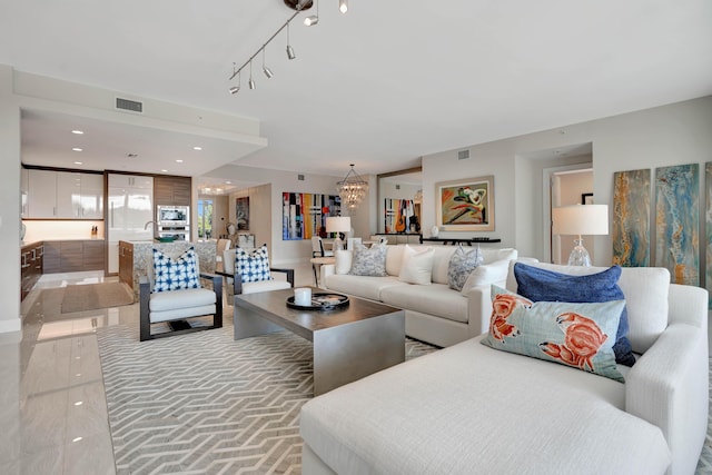 tiled living room featuring a chandelier