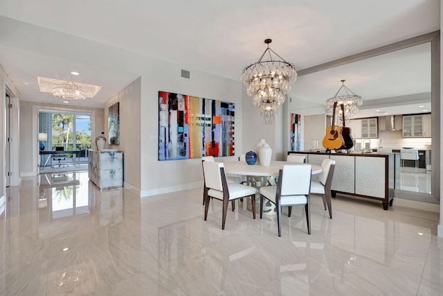 dining room featuring an inviting chandelier and a tray ceiling