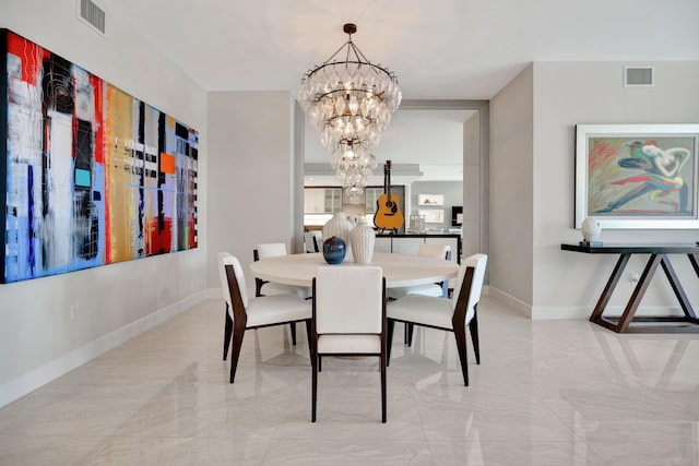 dining space with an inviting chandelier