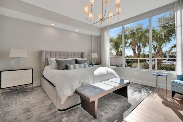 bedroom with an inviting chandelier and light wood-type flooring