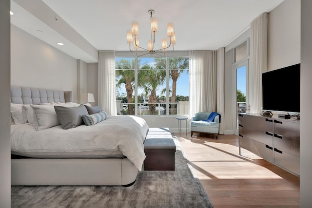 bedroom with a notable chandelier and light hardwood / wood-style floors