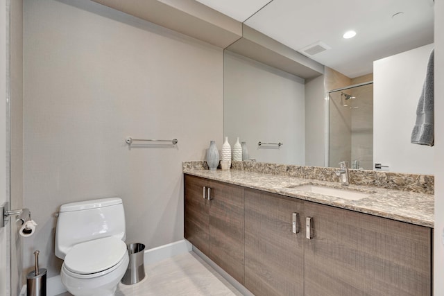 bathroom with toilet, walk in shower, and vanity