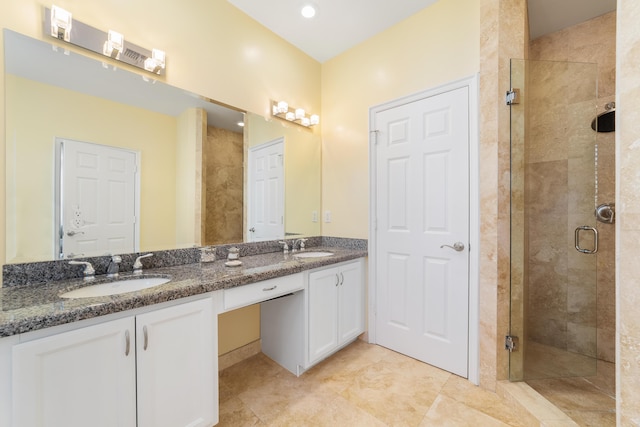 bathroom featuring walk in shower, tile patterned floors, and vanity