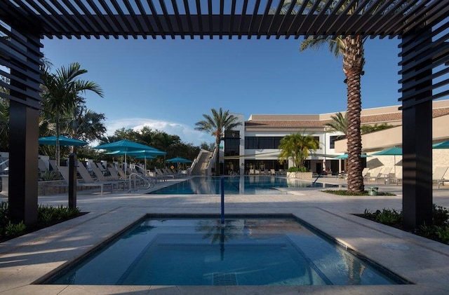 view of swimming pool featuring a patio area and a hot tub