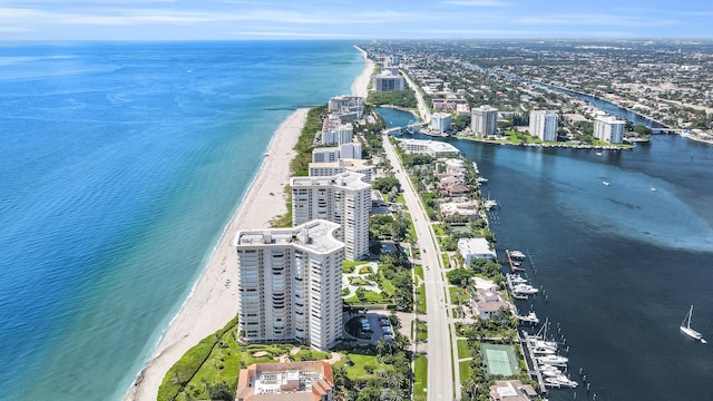 drone / aerial view with a water view and a beach view