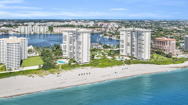 drone / aerial view with a water view and a view of the beach