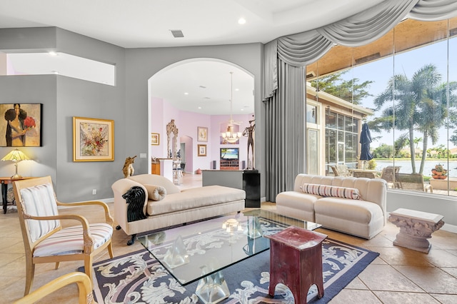 tiled living room featuring an inviting chandelier