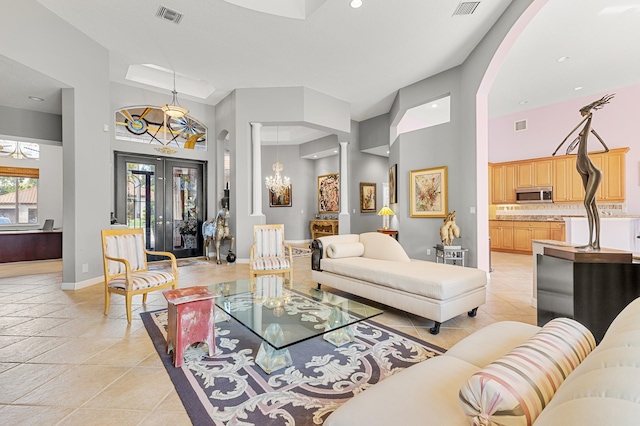 tiled living room featuring french doors and a towering ceiling