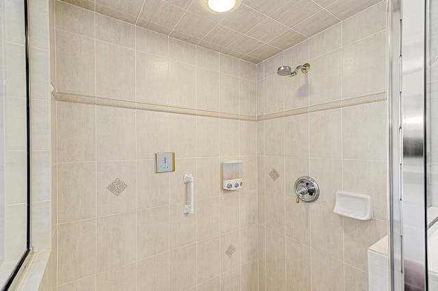 bathroom with tiled shower