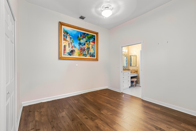 spare room with hardwood / wood-style flooring