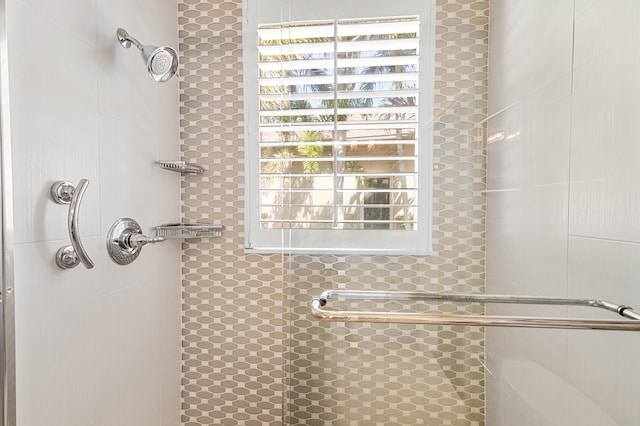 bathroom featuring a shower with shower door