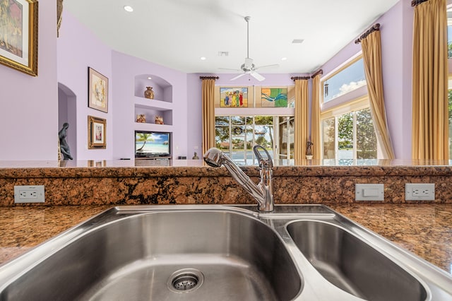 interior details with sink, built in shelves, and ceiling fan