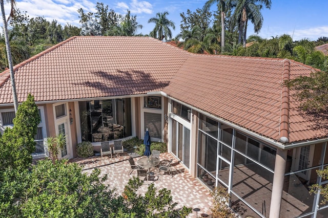 back of house featuring a sunroom and a patio