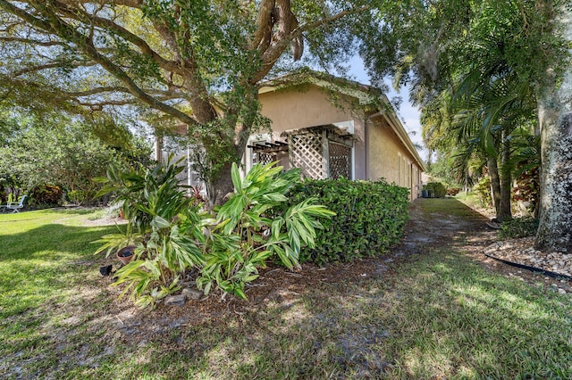 view of property exterior featuring a lawn