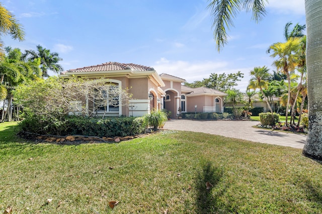 mediterranean / spanish home with a front yard