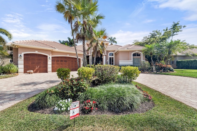 mediterranean / spanish-style home with a garage