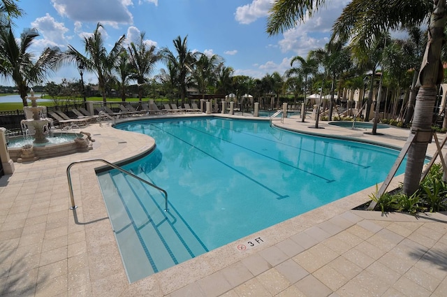 view of swimming pool featuring pool water feature